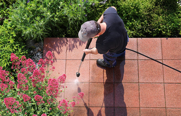 cleaning patio with a garden hose