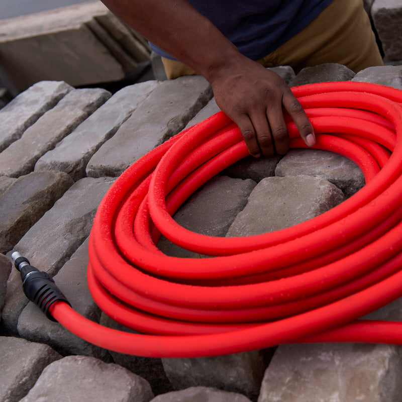 Man touching a coiled red hose