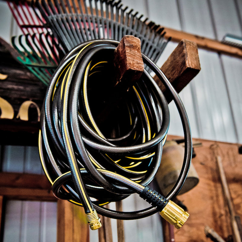 A black and yellow hose wrapped up in storage