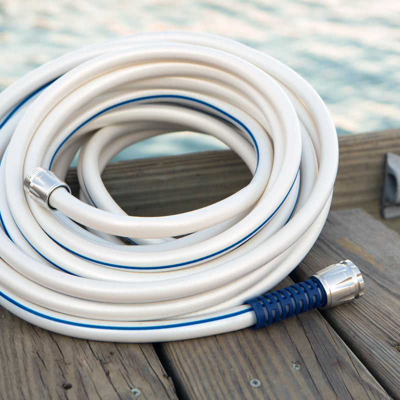 A rolled up white and blue hose sitting on a wooden dock