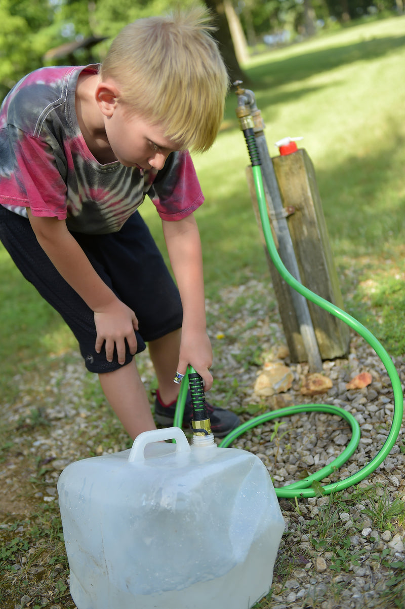 Child filling a water jug with the Leader Hose