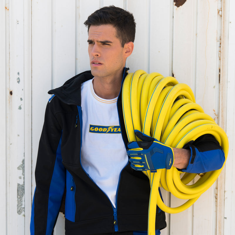 A man holding a large yellow hose around his arm