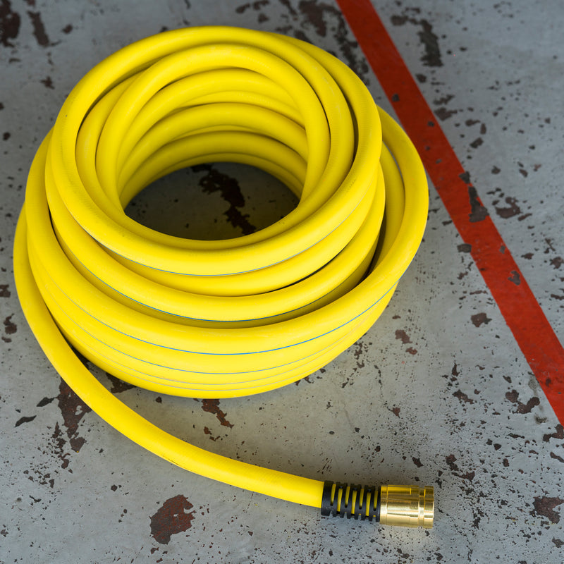 Yellow hose coiled up on a concrete floor