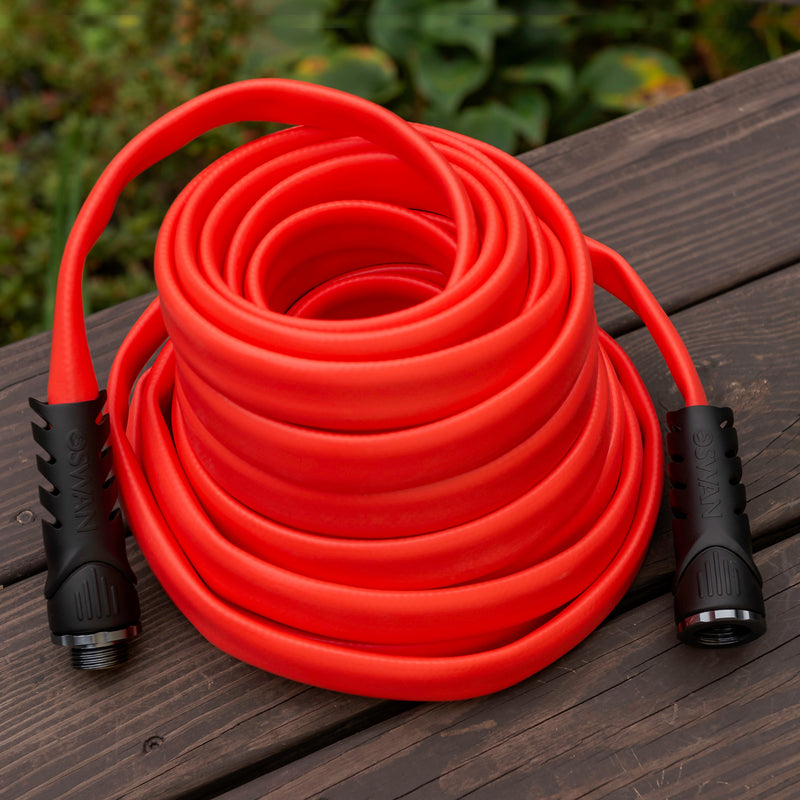 A coiled up red hose showing black couplings