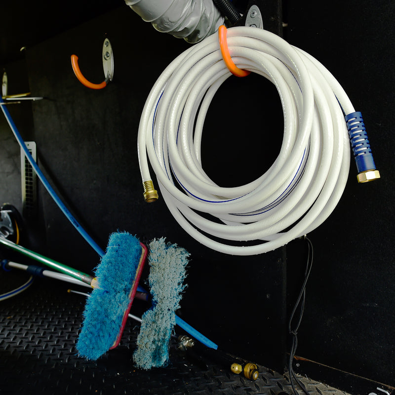A white and blue marine hose hanging in storage