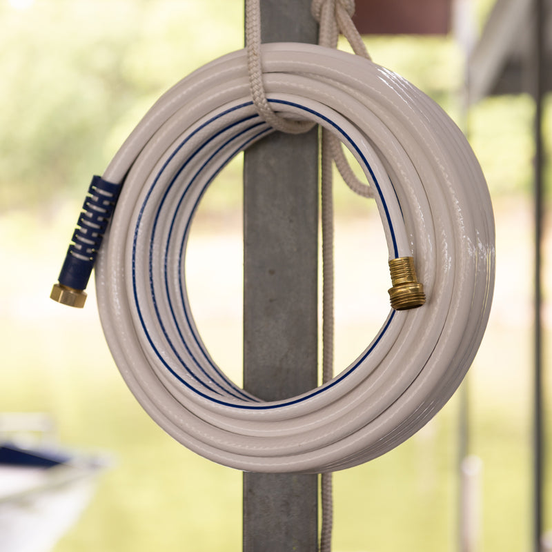 A white and blue hose hanging for storage