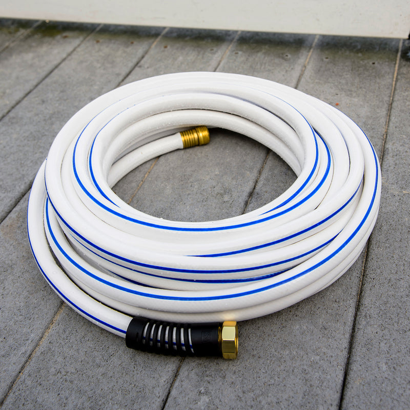A rolled up white and blue hose sitting on a wooden dock