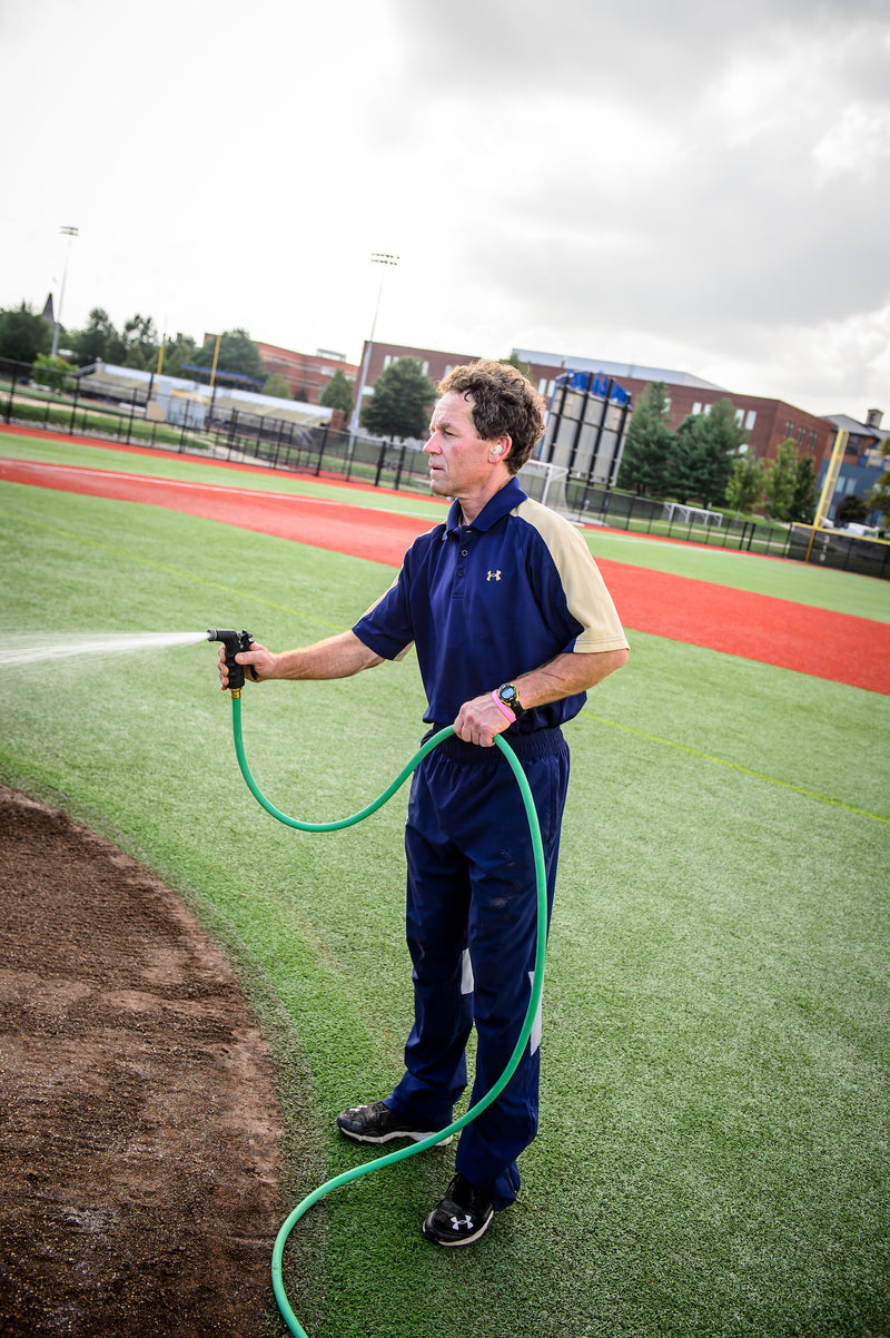 Man watering a sports field