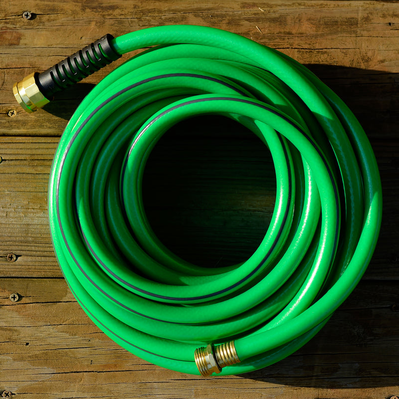 Green Element UltraLITE hose wrapped up on a wooden deck