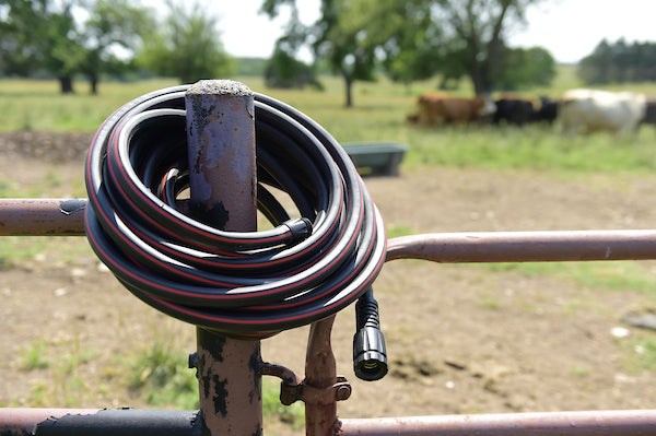 Viper High Performance Rubber hose hanging on a cow fence