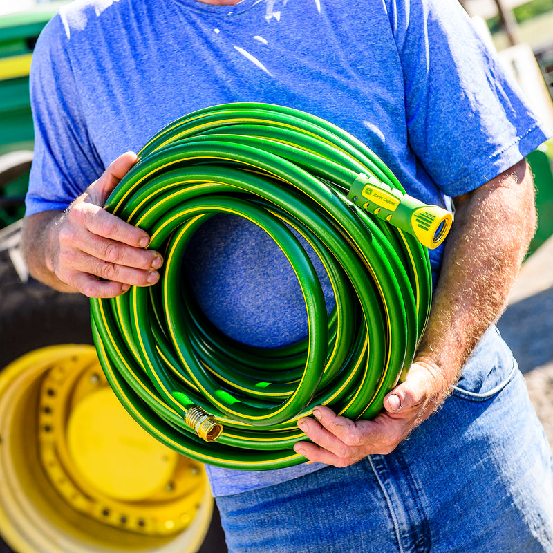 Man holding a John Deere hose