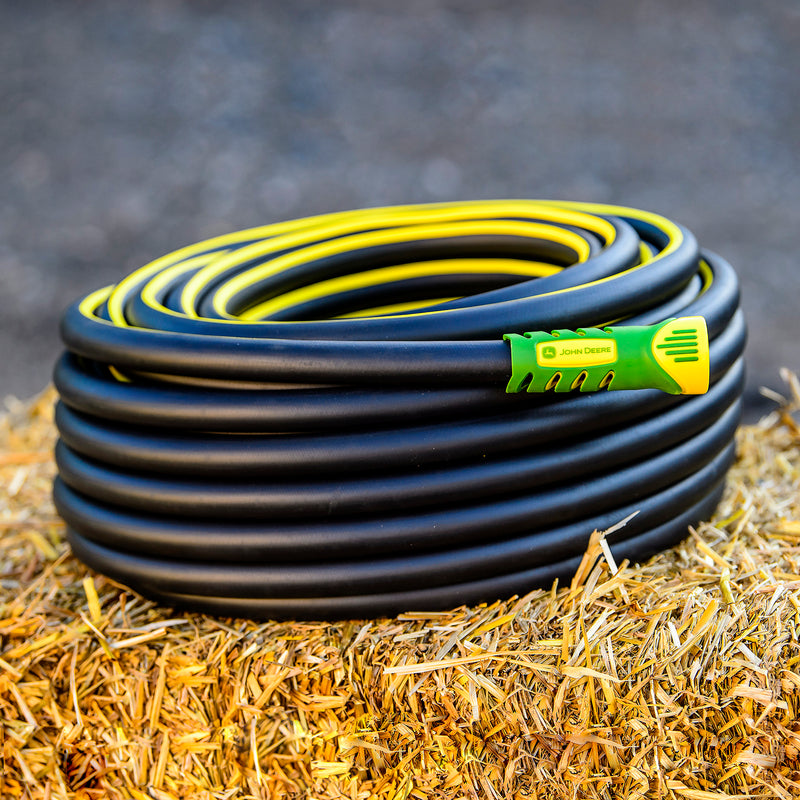 John Deere Rubber Hose coiled up on a hay bale